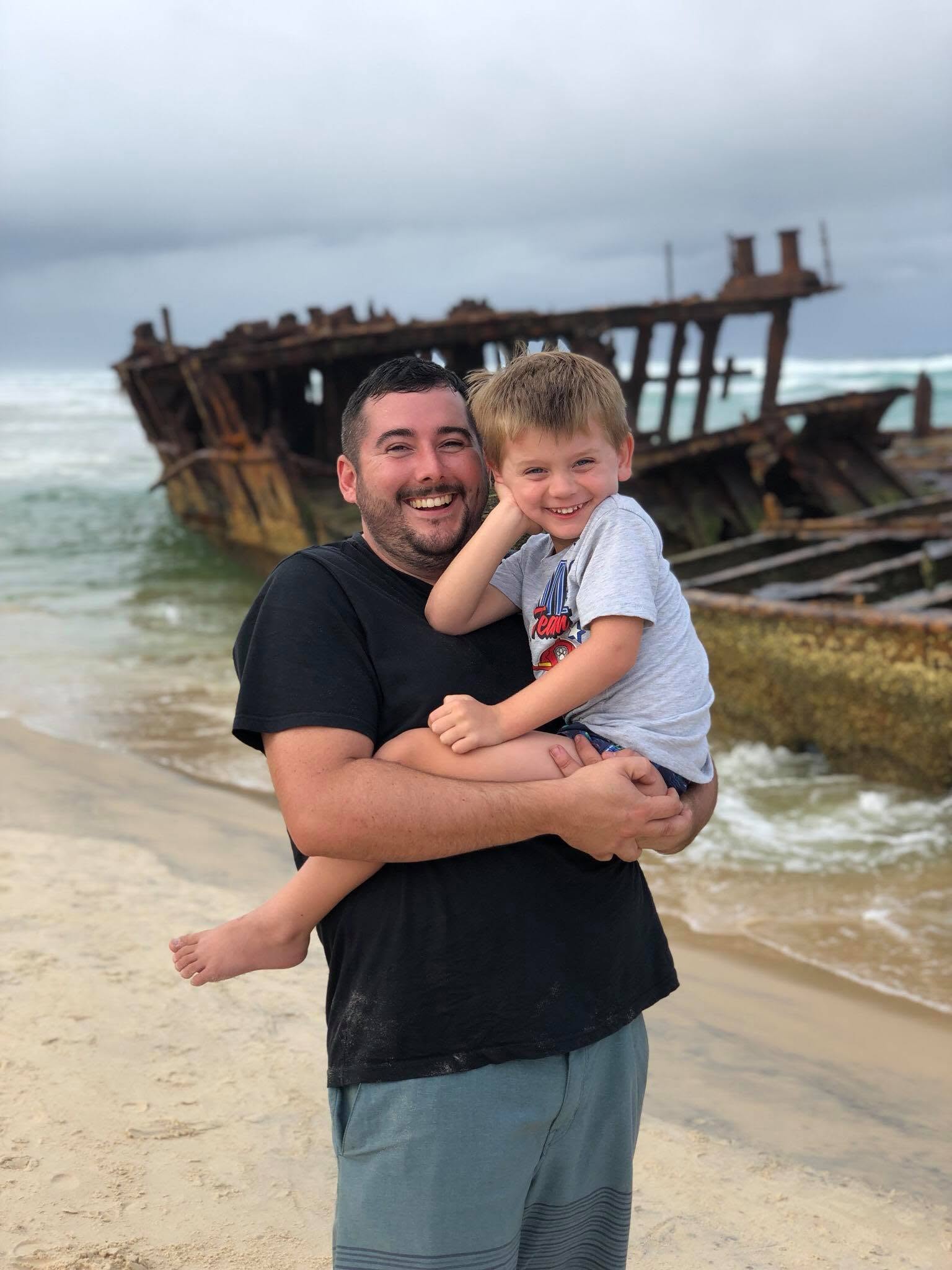 Shayne Taylor Shayne holding Bentley on the beach